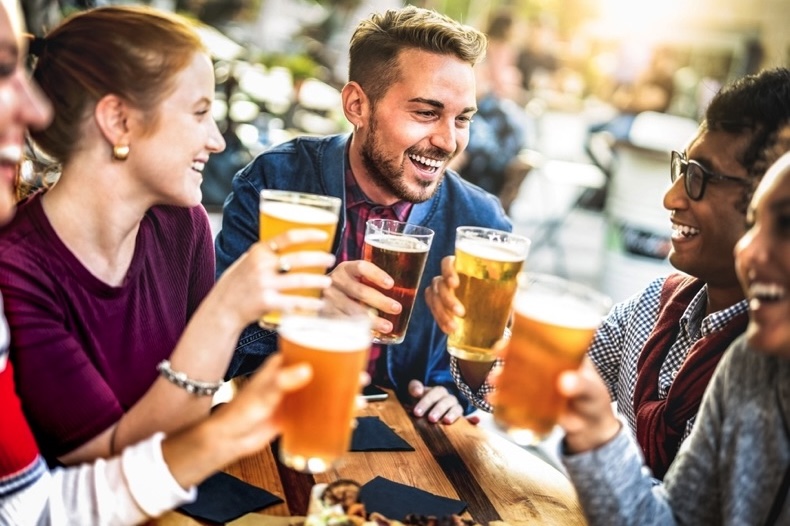 Young people drinking beer together at a festival